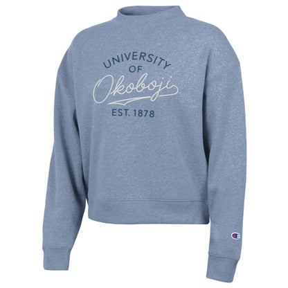 Wildflower pale blue Champion womens Triumph fleece crew featuring embroidered University of Okoboji Est. 1878 script artwork