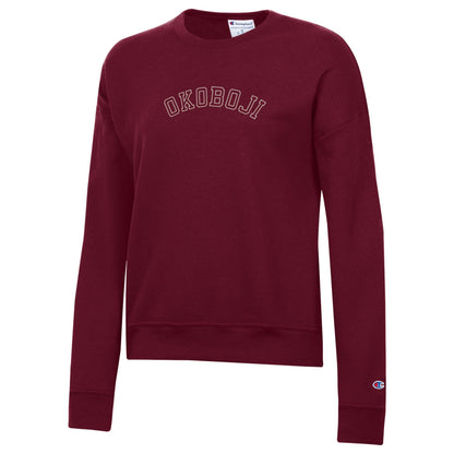 Maroon Champion womens Powerblend crewneck sweatshirt with outlined arched OKOBOJI chest graphic